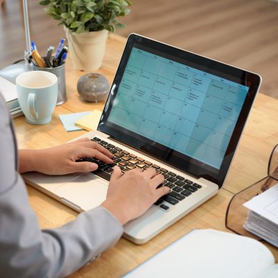 Business lady filling calendar for the month